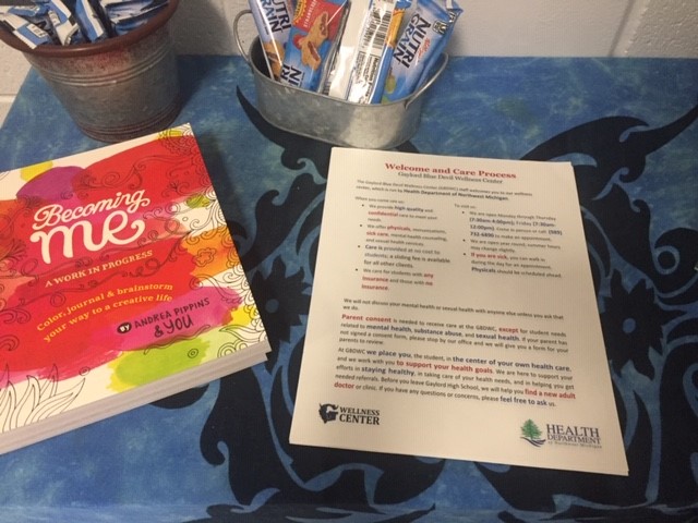 Table with clinic intake flyer, care book, and protein bars
