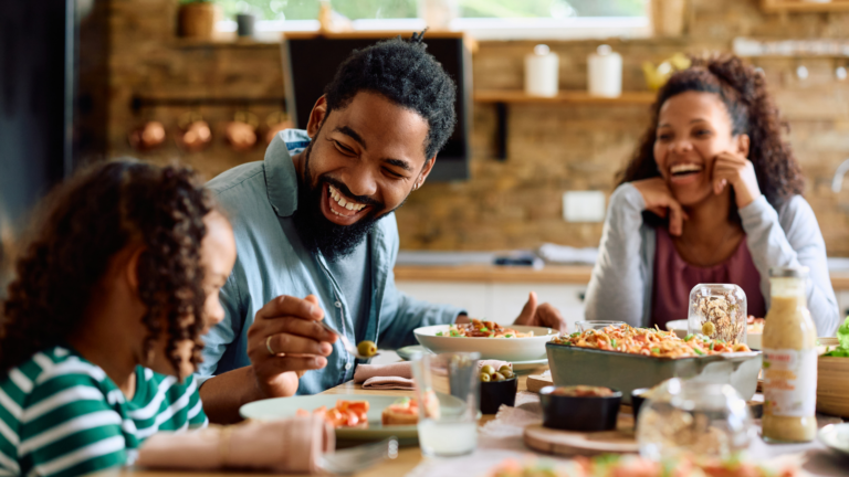 Family sitting around a table eating.
