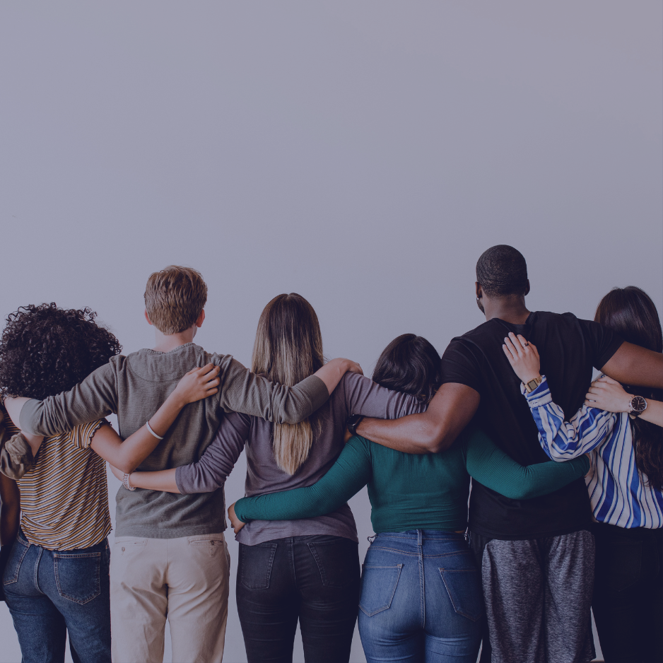 Rearview of diverse people hugging each other.