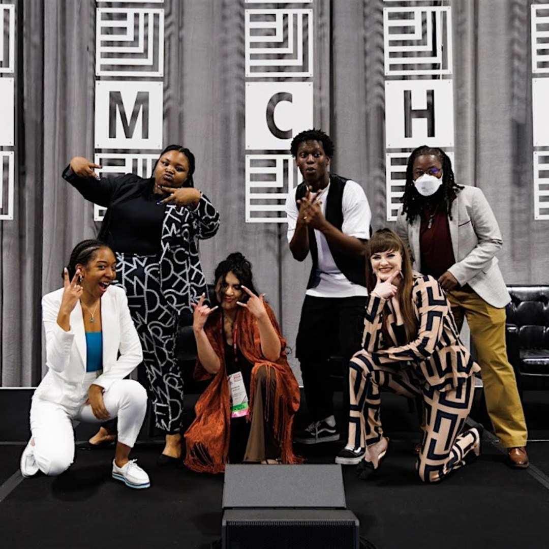 A group of young presenters pose and smile on the stage of the 2024 AMCHP Annual Conference in Oakland, CA.