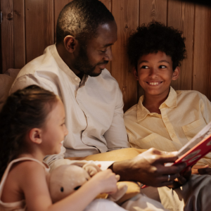 Father reading to two children