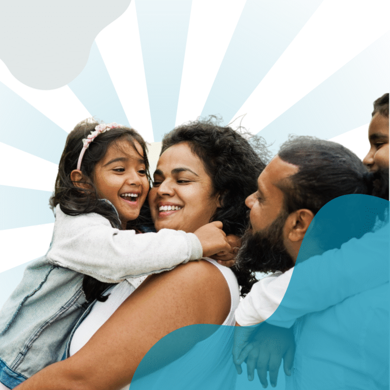 Family of four hugging and smiling.